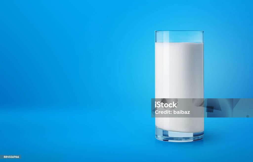 Glass of milk on blue background Glass of fresh milk on blue background Milk Stock Photo