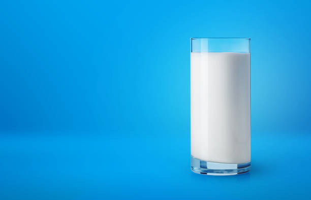 Glass of milk on blue background Glass of fresh milk on blue background full term stock pictures, royalty-free photos & images