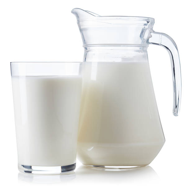 istock Glass and jug of milk 884557454