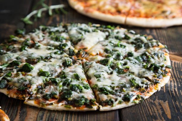 istock Varied pizzas on a wooden table 884557642