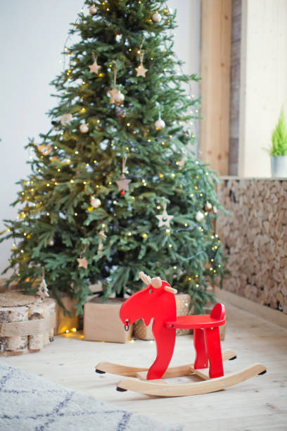 istock red rocking deer near Christmas tree 884560290