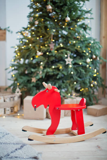 istock red rocking deer near Christmas tree 884560644