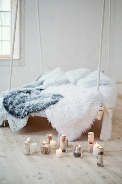 istock Hanging bed and burning candles 884560840