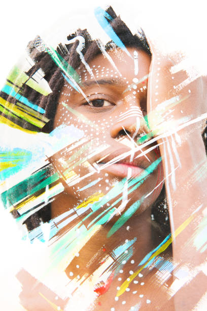 istock Paintography. African man with traditional style face paint dissolving behind colorful watercolor strokes 884577804