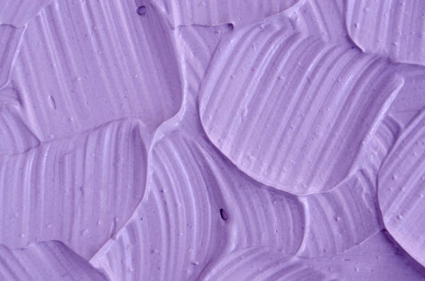 istock Lavender face cream (mask) texture close up. Brush strokes. Selective focus. Abstract background 884605268