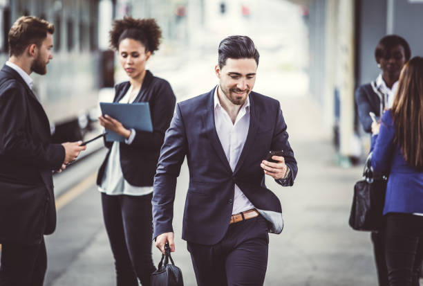 istock Businessman Walking Along Train Station Platform 884607754