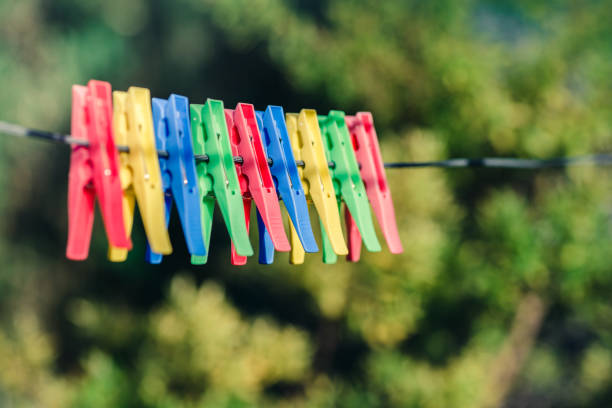 istock Colorful pegs on clothesline 884616338