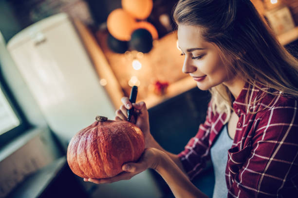 istock Woman with Halloween pumpkin. 884618504