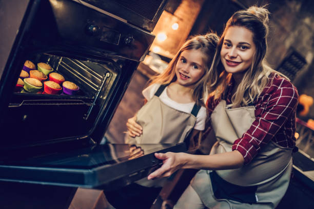 istock Mom with daughter cooking. 884618658