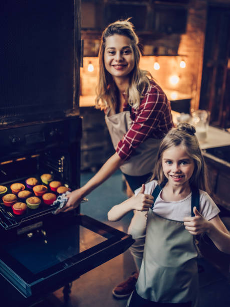 istock Mom with daughter cooking. 884618694
