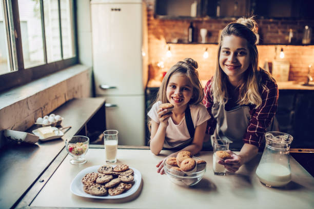 istock Mom with daughter on kitchen. 884618716