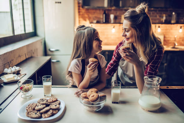 istock Mom with daughter on kitchen. 884618744