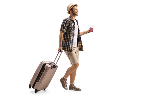 Tourist with a passport and a suitcase walking Full length profile shot of a tourist with a passport and a suitcase walking isolated on white background full body isolated stock pictures, royalty-free photos & images