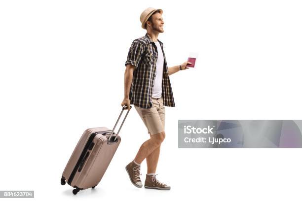 Tourist With A Passport And A Suitcase Walking Stock Photo - Download Image Now - Suitcase, Travel, Tourist