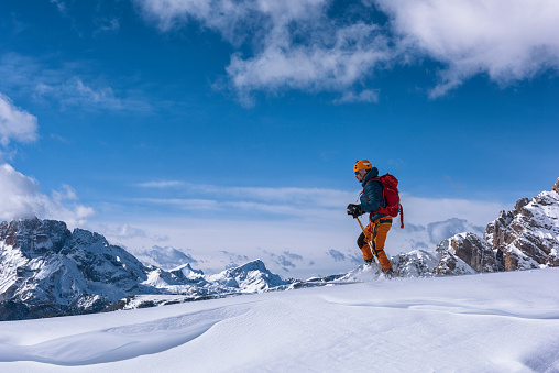 Side viw of young man ski touring in Dolomites, Italy