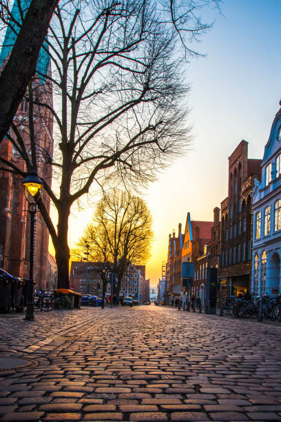 istock Old town with cobbled streets and  trees in Europe at sunset 884629124