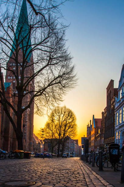 istock Old town with cobbled streets and  trees in Europe at sunset 884629184