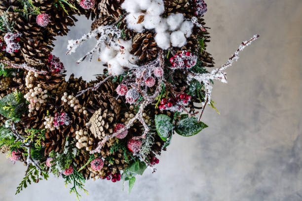 istock Christmas wreath with cones and berries and leaves 884629396