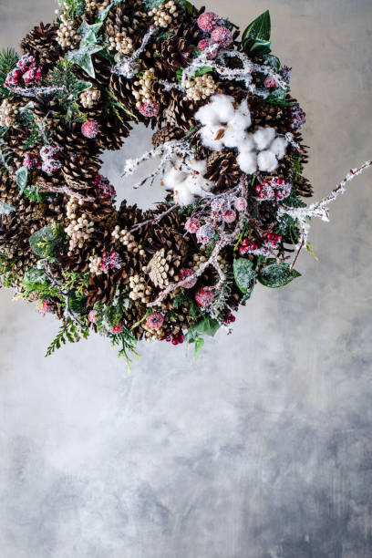 istock Christmas wreath with cones and berries and leaves 884629402