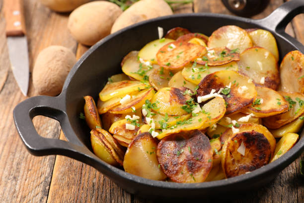 istock baked potato with garlic and herbs 884638388