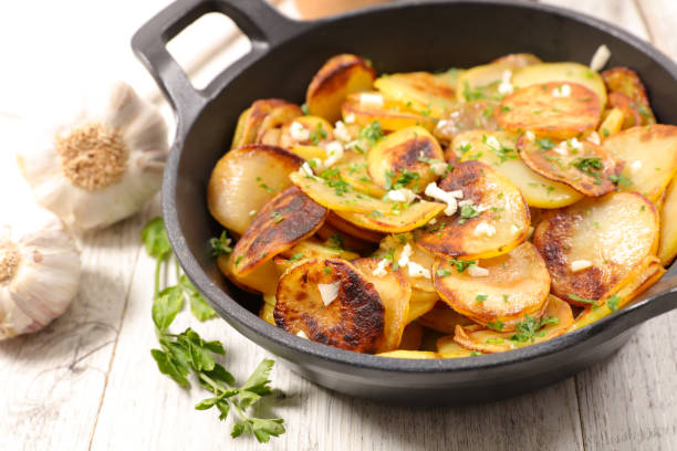 istock baked potato with garlic and herbs 884638390