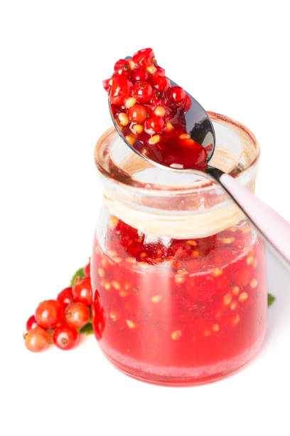 istock Red current homemade jam on white background 884641570