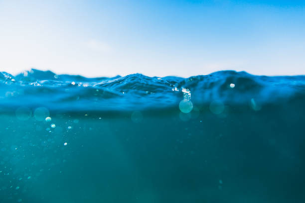 istock Underwater waves in tropical sea and sun rays. Water texture in ocean 884644448