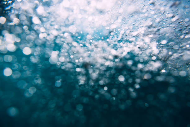 istock Wave underwater and bubbles. Blue ocean in underwater 884646510