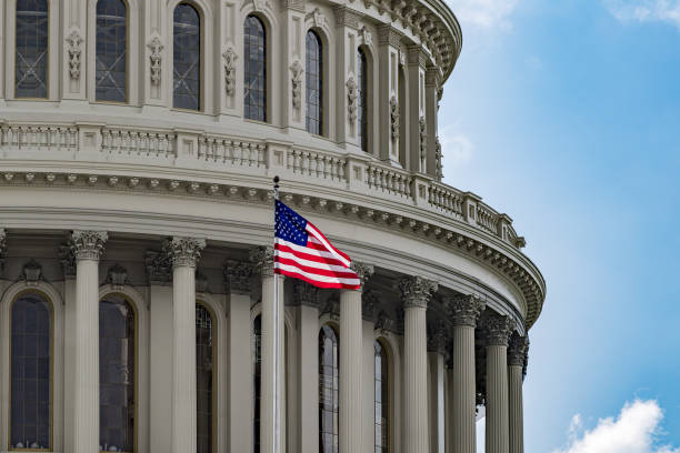 istock Washington DC Capitol view on cloudy sky background 884646636