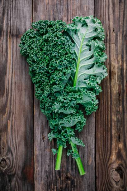 istock Fresh raw green superfood kale curly cabbage leaves 884646722