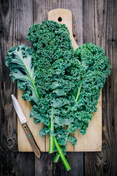 istock Fresh raw green superfood kale curly cabbage leaves 884646862