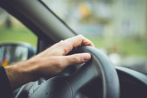 istock Hand on steering wheel. Man driving 884649790