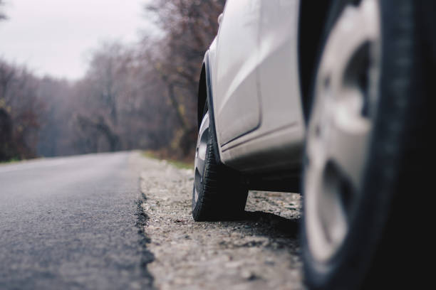 istock Close up to a white car parked on the road 884650006