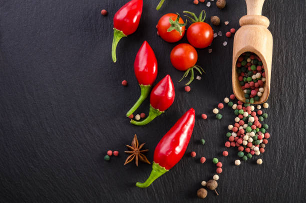 istock Different spices with tomato and  peppers on a black background 884651396