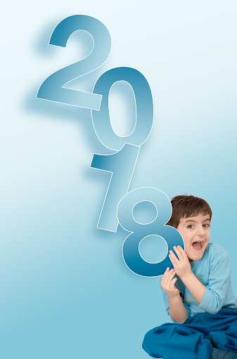Boy holding the number 2018 for a happy new Year
