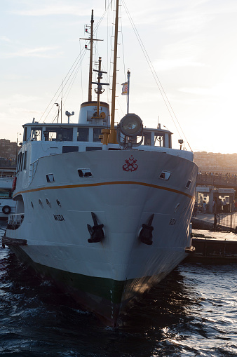 Istanbul, Turkey - September 2, 2016: Sunset view from the Golden or Halic in golden hour, passenger ferries and generic architecture of Eminonu and Karakoy, the historical districts of Istanbul, Turkey.