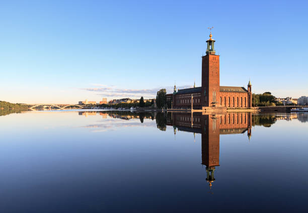 stockholm city hall with reflection on calm water - international landmark sunny lake sky imagens e fotografias de stock
