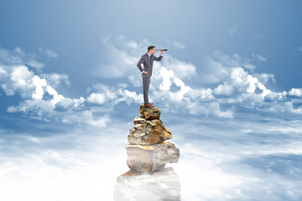 istock Businessman searching through telescope 884663530