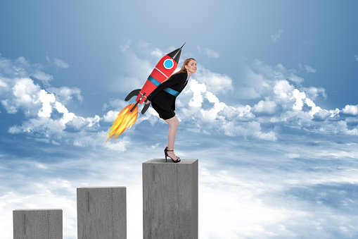 Businesswoman taking off with jet pack rocket on top of bar graph block