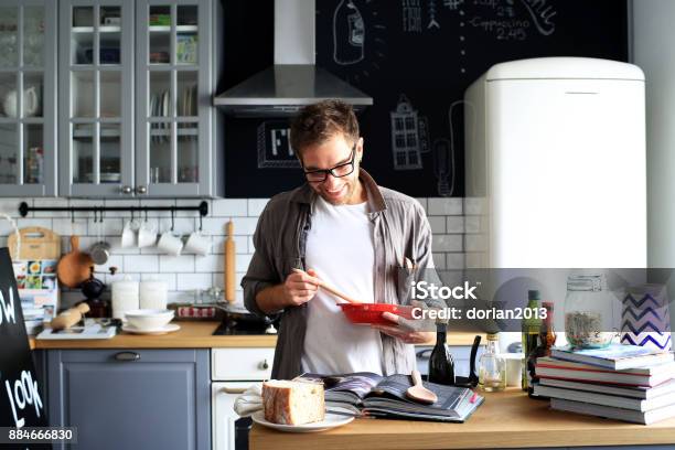 Young Man Cooking Lunch Stock Photo - Download Image Now - Adult, Apron, Book