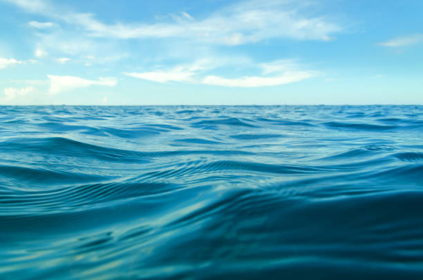 istock ocean waves from the near with blue sky 884671788