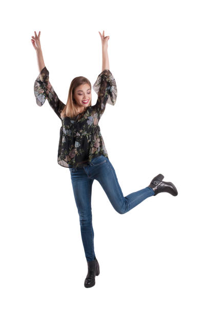 istock beautiful girl in jeans, glee dancing isolated, jumping, active 884674892
