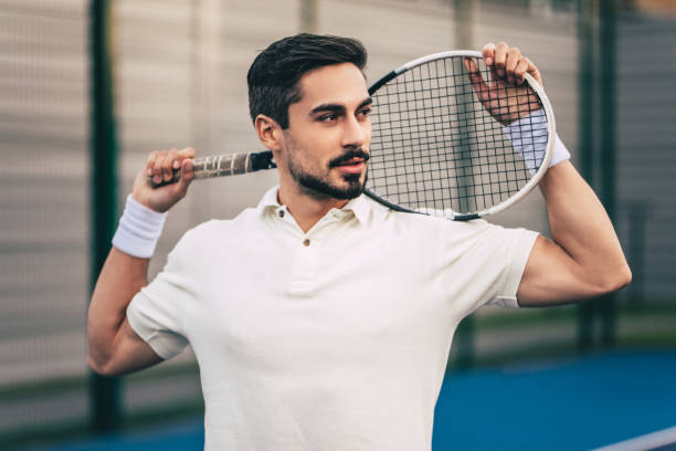 istock Man on tennis court. 884678716