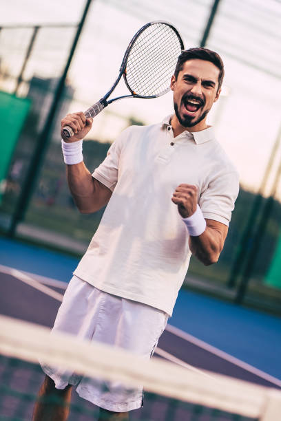 istock Man on tennis court. 884678780