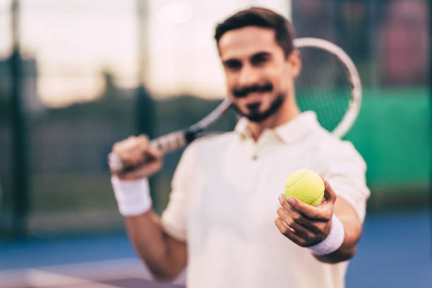istock Man on tennis court. 884678850