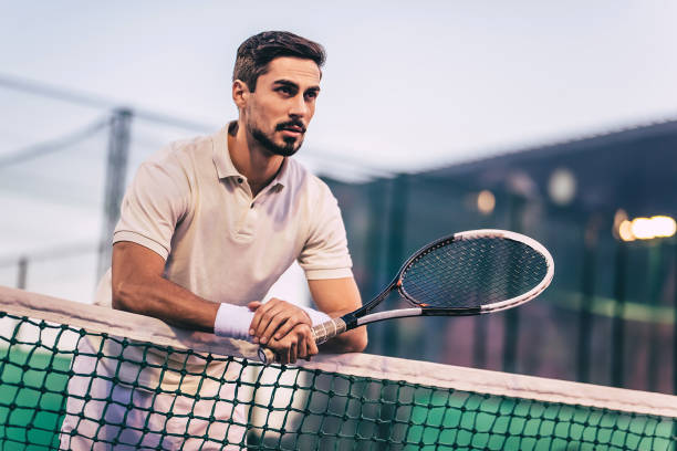 istock Man on tennis court. 884678892