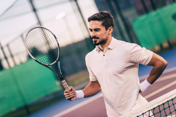 istock Man on tennis court. 884678896
