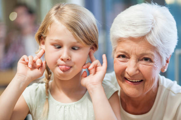 making silly faces for grandma to smile - making a face sticking out tongue women nerd imagens e fotografias de stock