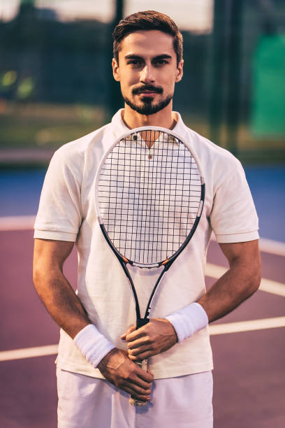 istock Man on tennis court. 884679040