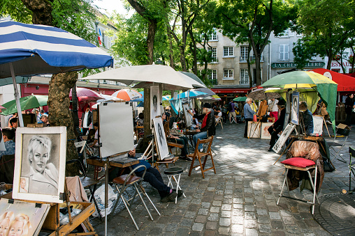 Paris, France - June 7, 2016: Place du Tertre in Montmartre with street artists ready to paint tourists.